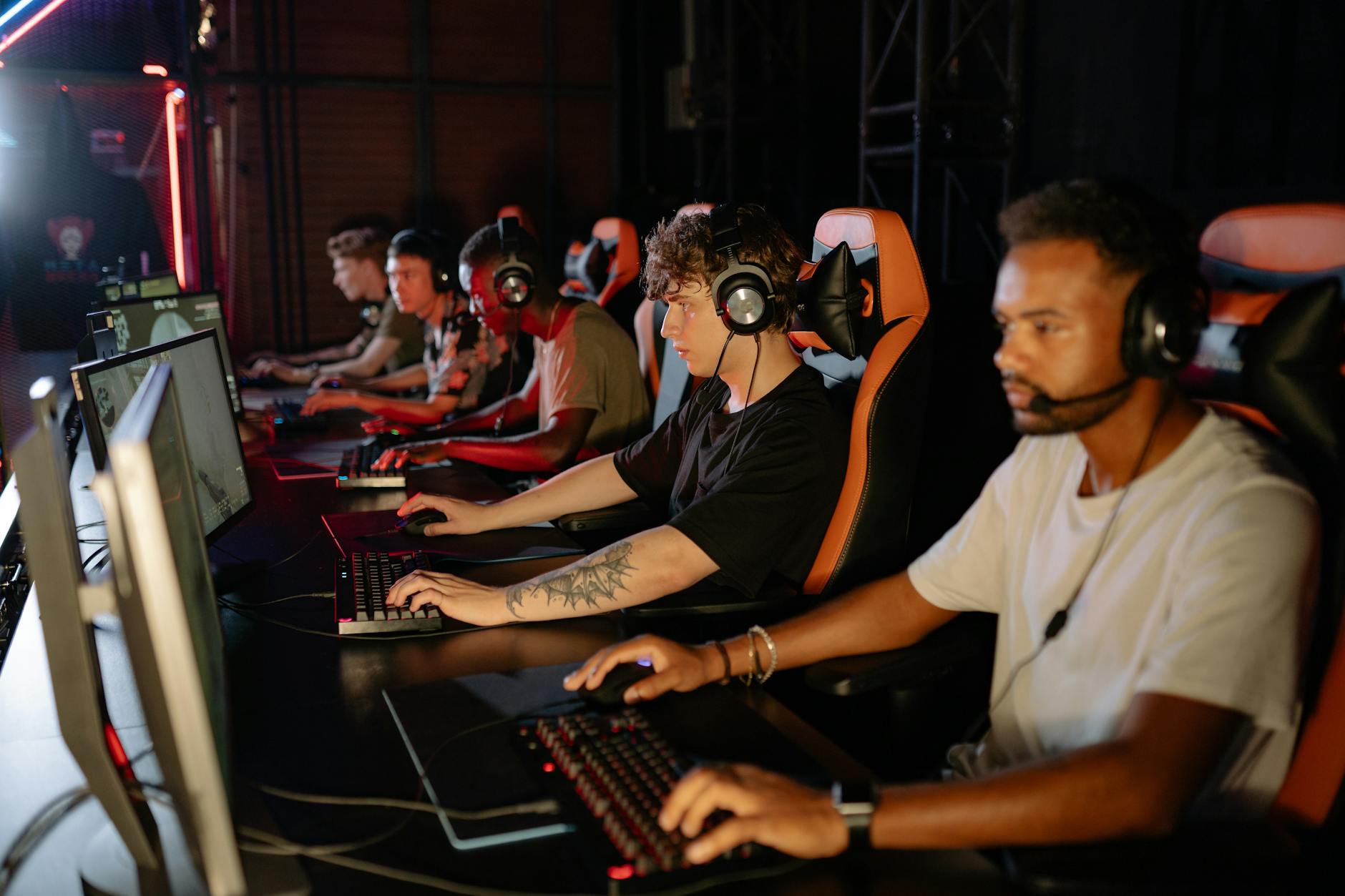 a group of gamers looking serious in a tournament, this section of article show cases the benefits of blue lens glassess in gaming tournament.